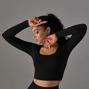 Close-up of seamless black knit fabric with honeycomb texture and square neckline