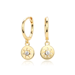 Macro shot of gold sunburst star earrings with centered sparkling cubic zirconia