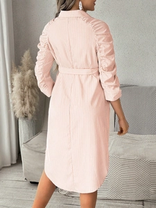 Detail view of pink striped maternity dress featuring back waist belt and pleated sleeves