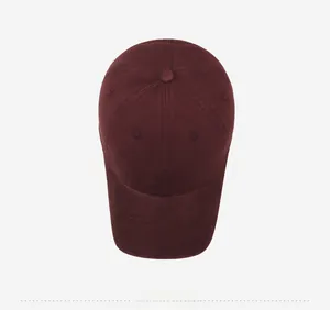 Top down view of burgundy washed cotton baseball cap with white TAOFEILE embroidery