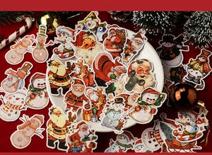 Close-up of retro Christmas theme stickers with gold stamping and vintage holiday illustrations