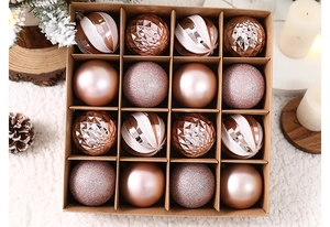 Macro shot of 16-piece rose gold Christmas ball set in a display box with festive decor