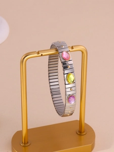 Detail of silver stretch bracelet with pink, yellow, and purple acrylic gemstones