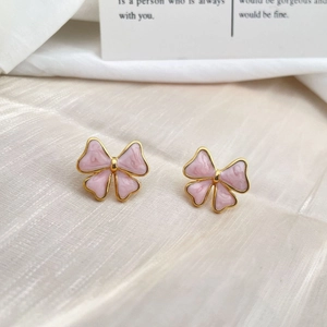 Elegant gold bow earrings with pink marble texture inlays for a sophisticated style
