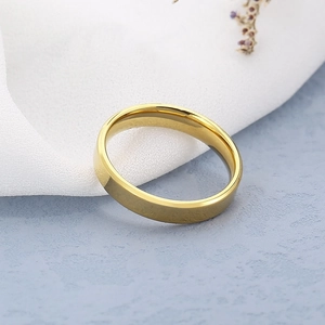 Macro shot of minimalist gold double-beveled mirror-finish stainless steel ring