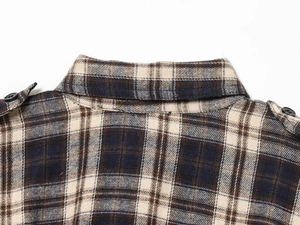 Detail of plaid midi dress collar with epaulettes and button on flannel fabric