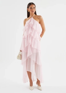 Front view of a pink tiered ruffle halter dress in lightweight chiffon fabric