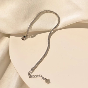 Detailed close-up of S925 silver tennis bracelet with cubic zirconia and heart pendant