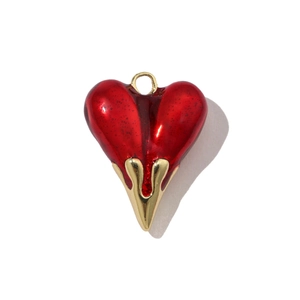 Close-up of red enamel heart pendant with flowing gold-tone finish for DIY jewelry