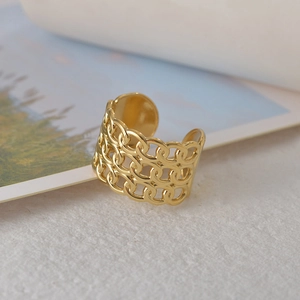 Macro detail of 14K gold interlocking chain ring with open adjustable band design