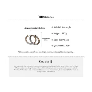 Detailed view of silver hoop earrings with rectangular crystals and size dimensions