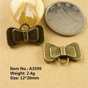 Macro detail of vintage zinc alloy bow charms A3599 with dimensions 12x20mm