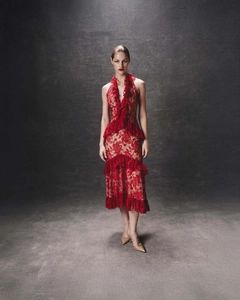 Detailed view of dark red lace texture and layered ruffle hem on backless dress