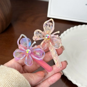Hollow butterfly acetate hair clips with iridescent finish and central rhinestones
