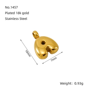 Macro detail of 3D bubble letter A pendant in 18K gold plated stainless steel