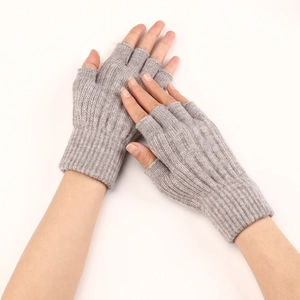 Detailed knit texture of light gray fingerless wool gloves worn on hand for winter warmth