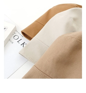 Close-up of three cotton bucket hats in caramel, beige, and khaki with twill texture