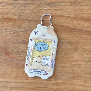 Detailed view of a cute cartoon hamster card holder with a white bead chain on a wood table
