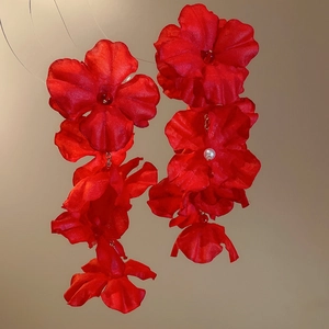 Detailed close-up of bridal red fabric flower earrings with pearls and crystal bead accents