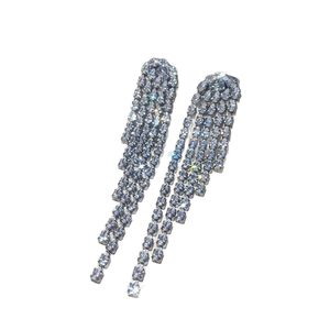 Elegant silver tassel earrings with sparkling teardrop rhinestones on white background