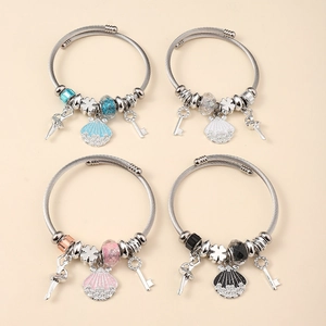 Detail of four silver beaded bracelets with colorful charms and open screw design