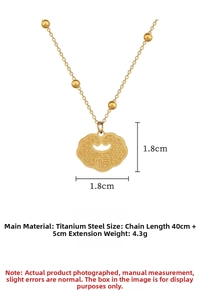 Macro detail of gold titanium steel Fu lock pendant with size 1.8cm and 45cm chain length