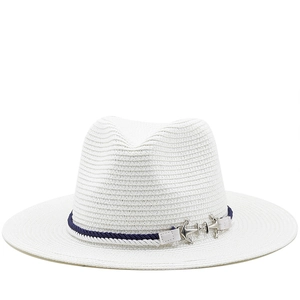 Close-up of white Panama straw hat featuring blue-white rope and silver anchor charm