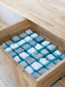 Close-up of DIY adjustable plastic drawer dividers for organizing socks and small items