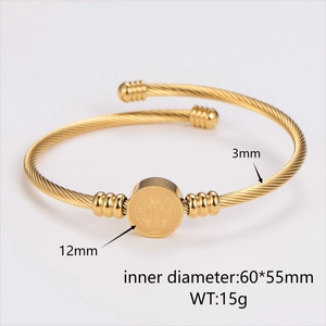 Luxurious gold stainless steel open bangle with St. Benedict medal and twisted rope detail