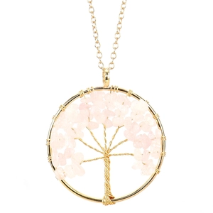 Macro detail of handmade Tree of Life pendant with pink crystals and gold wire wrapping