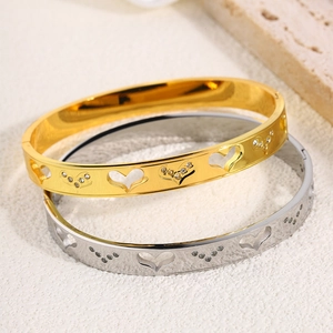 Titanium steel bangles with hollow heart designs and sparkling zircon in gold and silver