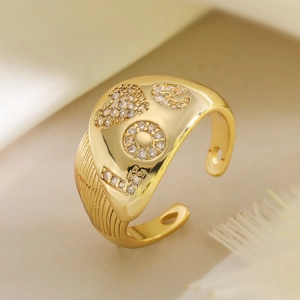 Adjustable gold LOVE letter ring with cubic zirconia stones in a luxury aesthetic