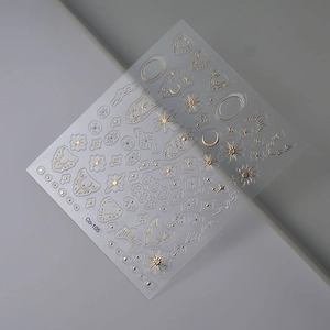 Detail of gold celestial nail stickers Co-105 featuring moon and sun embossed patterns