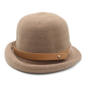 Detail of the fine knit texture and brown leather strap with a gold metal buckle