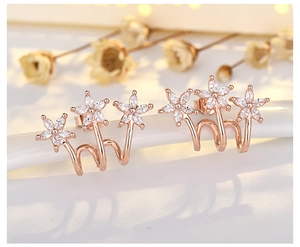Macro detail of rose gold climber earrings featuring three sparkling zircon flowers