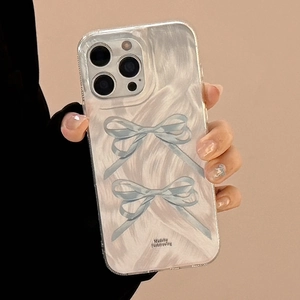 Close-up of clear iPhone case with two blue hand-drawn bow patterns and small text