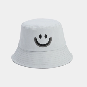 Close-up of smile face embroidery on light grey cotton bucket hat with fine stitching