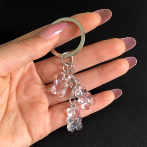 Detail showing three transparent gummy bear resin charms with silver metal keychains
