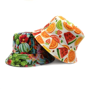 Detail view of cotton sun hats featuring tropical watermelon and cactus print patterns