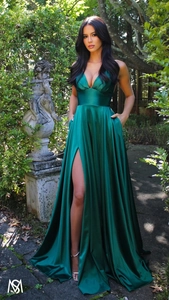 Detail view of emerald green silk gown featuring a deep V-neck and elegant high side slit