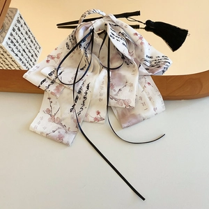 Detail of white satin hair clip with pink plum blossoms and black silk tassels