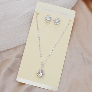 Detailed view of silver bridal jewelry set with sparkling cubic zirconia tassels