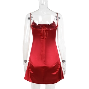 Detail of red satin mini dress featuring crisscross back tie design and slim fit silhouette