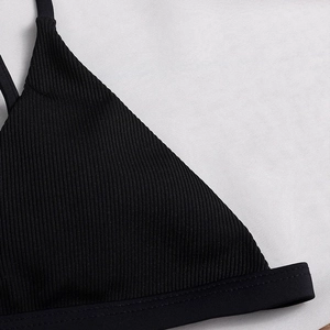 Black ribbed bikini set featuring halter neck tie and triangle top with textured fabric