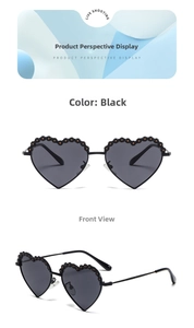 Detailed view of heart-shaped polarized sunglasses with metal frame and black flower accents