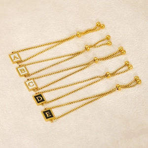 Adjustable gold stainless steel letter pendant bracelet with black and white shell inlay