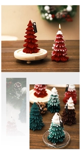 Detail showing handmade Christmas tree candles with snowy tips on a rustic wood base