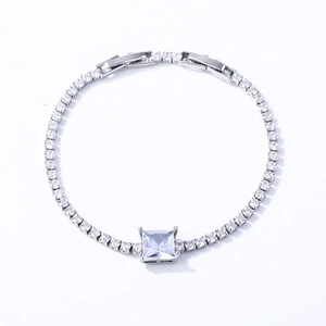 Macro view of silver tennis bracelet with square-cut zirconia and adjustable clasp