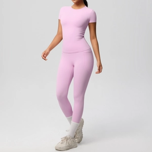 Detail view of light pink yoga set featuring breathable short sleeve top and high waist leggings
