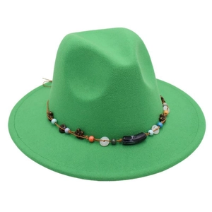Close-up of vibrant green wool felt fedora featuring bohemian beaded ethnic band detail